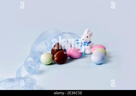 Painted eggs, chocolate eggs and cute bunny figurine Stock Photo