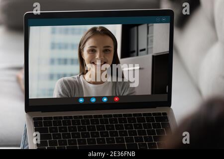 Smiling woman on laptop screen engaged in online call Stock Photo