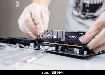 Moscow, Russia -25 Dec 2020: Installing ram memory module on desktop computer motherboard closeup Stock Photo