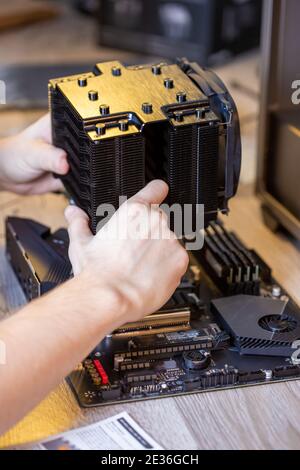 Installing a processor fan on the computer motherboard. Computer repair, PC assembly Stock Photo