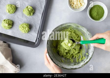 closeup of female hands making matcha green tea cookie Stock Photo