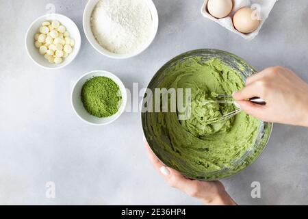 female hands mixing dough with whisk Stock Photo