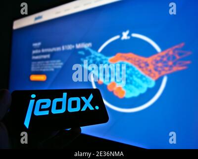 Person holding smartphone with logo of German software development company Jedox AG. Focus on mobile phone screen. Unmodified photo. Stock Photo