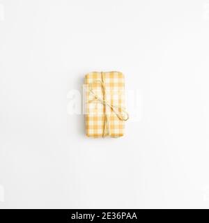 Yellow check pattern gift box isolated on white background. top view, copy space Stock Photo