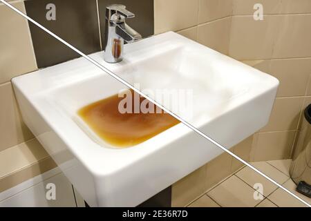 Dirty sink before and after clearing the blockage. Clog problems in the bathroom and toilet Stock Photo