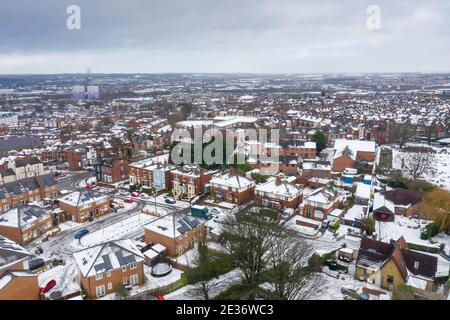 Aerial photo of a snowy day in the city of Leeds in the UK, showing rows of terrace houses with snow covered roofs in the Village of Beeston in the wi Stock Photo