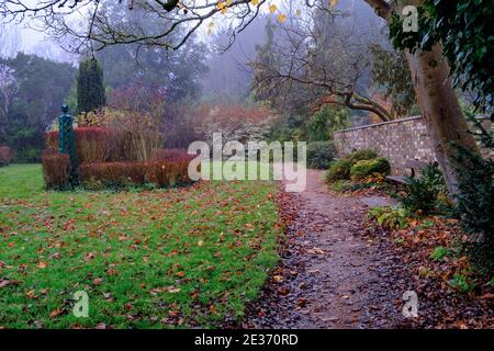 Foggy autumn day with leaves on ground at Peace Garden, Pinner Memorial Park, Northwest London, England. Stock Photo