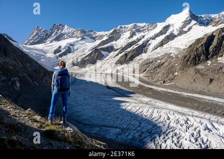 Mountaineer standing in front of glacier, high alpine mountain landscape, Lower Ice Sea, Finsteraarhorn, Agasszishorn, Grosses Fiescherhorn, Bernese Stock Photo