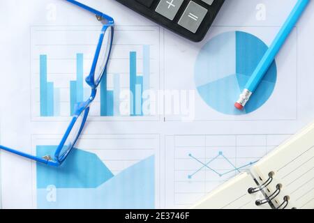 financial graph, calculator and notepad on table  Stock Photo