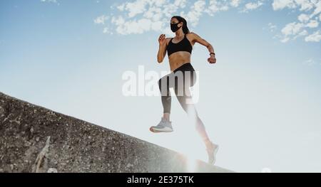 Sports woman running outdoors in the morning. Female athlete in running  attire exercising in morning Stock Photo - Alamy