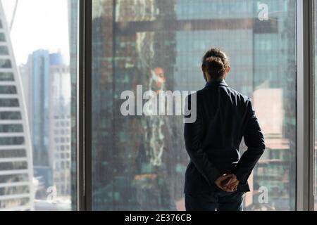 Back view of businessman look in distance thinking Stock Photo