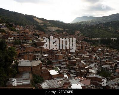 Panorama cityscape of colorful brick houses buildings in Comuna 13 San Javier neighborhood poverty slum hills slopes in Medellin Colombia South Americ Stock Photo
