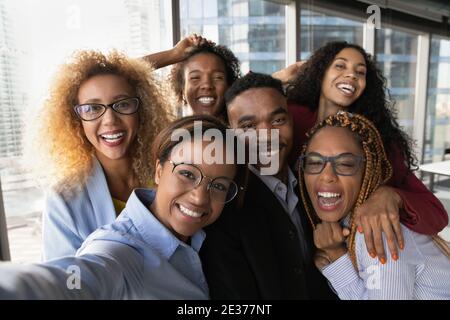Portrait of smiling diverse colleagues pose for selfie Stock Photo