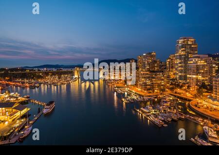 False Creek and Downtown Vancouver buildings at dusk in Vancouver, British Columbia, Canada.