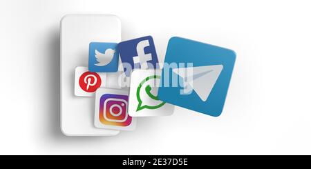Telegram vs whats app concept. View from above of 3D rendered famous social media application icons on white background and mobile phone. Stock Photo