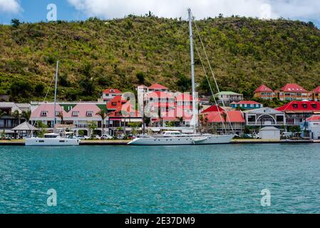 Gustavia, St Barths-- April 25, 2018. Yachts  in Gustavia harbor with the town and mountain in the background. Stock Photo