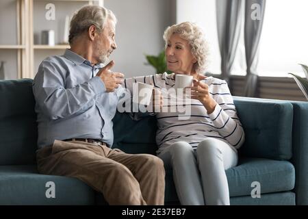Bonding affectionate family couple drinking morning coffee. Stock Photo