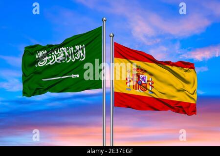 3D Rendering of Spain & Saudi Arabia Flags are Waving in the Sky - 3d illustration Stock Photo