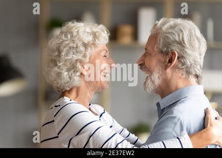 Smiling old mature family couple showing tender sweet feelings. Stock Photo