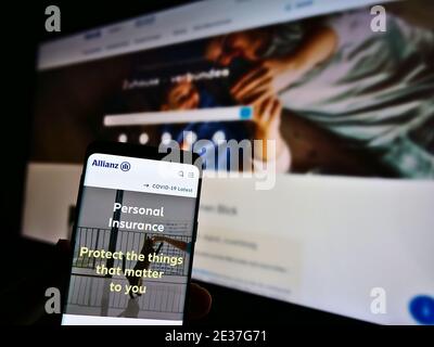 Mobile phone with website of German financial services and insurance company Allianz SE on display. Focus on center of mobile phone screen. Stock Photo