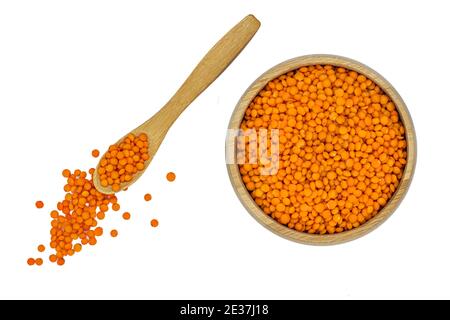 red lentil in wooden bowl and spoon isolated on white Stock Photo