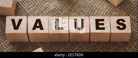 Values Word Written In Wooden Cubes on burlap background. Core values psychological concept. Stock Photo