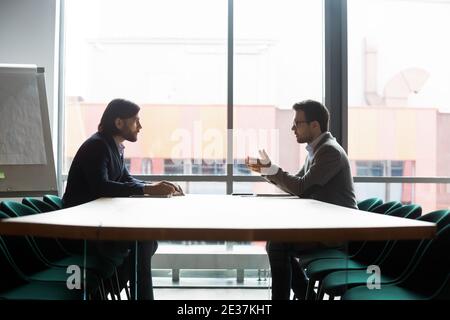 Focused confident young businessman making offer to partner. Stock Photo