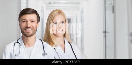 Female And Male Doctors Posing Standing In Hospital Hallway Indoors Stock Photo