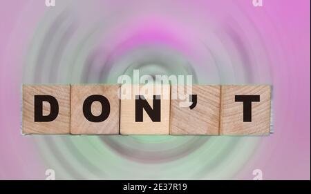 The words Don't on wooden cubes standing on swimming pool border and ocean landscape. Recommendations concept, business and lifestyle concept Stock Photo