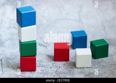Colorful wooden details of the constructor on a gray background. Stock Photo
