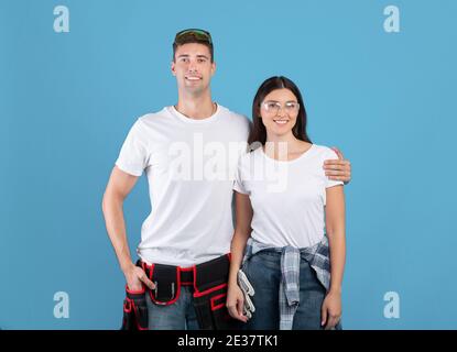 Repair Concept. Portrait Of Young Couple With Safety Glasses And Construction Belt Stock Photo