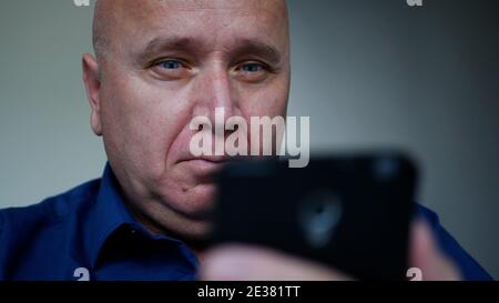 Businessman Texting a Message Using a Cellphone, One Person Accessing Social Media Stock Photo