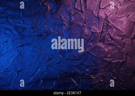Art plastered black wall texture background in neon light Stock Photo