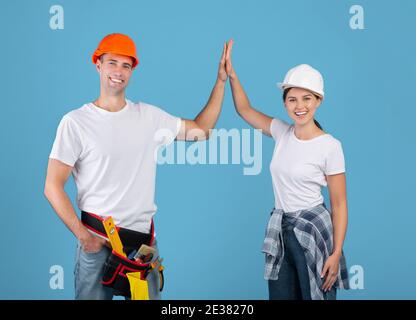 Workers giving high five to each other Stock Photo - Alamy