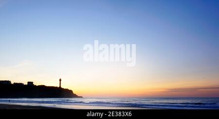 sunset over Biarritz lighthouse, Basque country, France. Waves with long exposure. Stock Photo