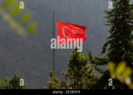 Huge Turkish flag waving between trees in Kemaliye or Egin, Erzincan, Turkey Stock Photo