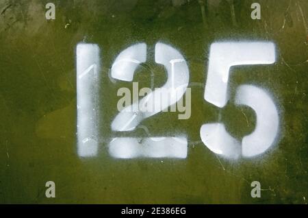 Number 125 painted on a telecom box in a street. Stock Photo