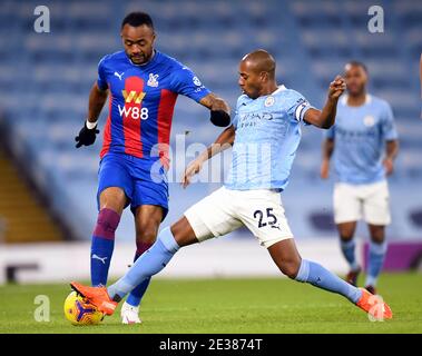 Crystal Palace's Jordan Ayew (left) and Manchester City's Fernandinho battle for the ball during the Premier League match at the Etihad Stadium, Manchester. Stock Photo