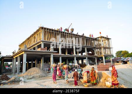 Women work at a construction Building on the Bank of Meghna River at Bhairab Bazar in Kishorganj. Bangladesh Stock Photo