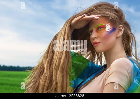 Portrait of a young, beautiful, white, woman with long hair and creative art make-up Stock Photo