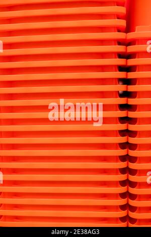 plastic trays form a pleasant geometric pattern as they sit nested and stacked in columns Stock Photo