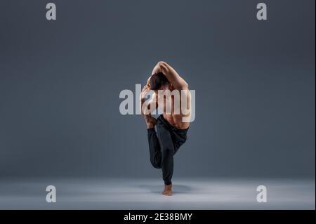 Yoga doing stretching exercise in studio Stock Photo