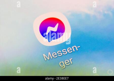 A closeup of the app logo for Facebook Messenger - an American messaging app and platform developed by Facebook, Inc. On a smartphone screen Stock Photo