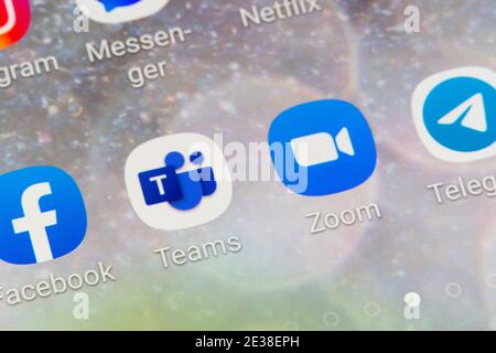 A closeup of the Microsoft Teams and Zoom video conferencing and web conferencing apps on a smartphone screen Stock Photo