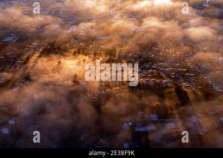 An aerial view of Launceston in Tasmania at dawn. The sun rises over the misty Tamar river. Stock Photo