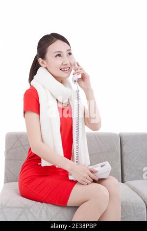 Portrait of young woman using telephone,paying New Year call  Stock Photo