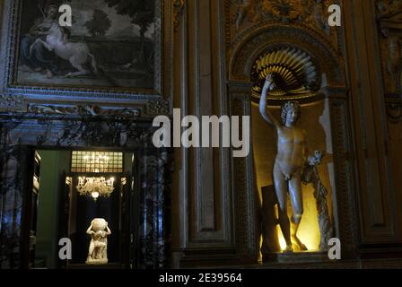 On left : statue of Atlas pictured in the gallery of Carracci at Palazzo Farnese in Rome, Italy on December 2010. Palazzo Farnese, the most monumental of Roman Renaissance palaces, which currently houses the French embassy in Italy, opens doors to public for the exhibition 'Palazzo Farnese - From the Renaissance to the Embassy of France' in Rome, Italy on december 17,2010. The exhibition aims to revive the intertwined stories of popes, cardinals, kings, ambassadors, and artists who, for five centuries, lived and passed through the Farnese Palace, helping to make it an exceptional and vibrant p Stock Photo