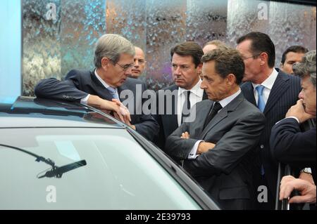 French President Nicolas Sarkozy flanked by Christian Estrosi, Chief executive officer of PSA Peugeot Citroen Philippe Varin and Jean-Louis Borloo visits the Paris Motor Show 'Mondial de l' Automobile' in Paris, France on October 1srt, 2010. The Paris Motor Show takes place every two years and is one of the largest expositions of motor vehicles in the world. This year, the emphasis of the show lies on electric cars and more than 300 exhibitors from 20 countries are expected to take part. Photo by Mousse/ABACAPRESS.COM Stock Photo