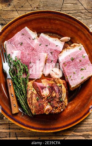 Smoked pork Slab Bacon meat slices on a rustic plate. wooden background. Top view Stock Photo