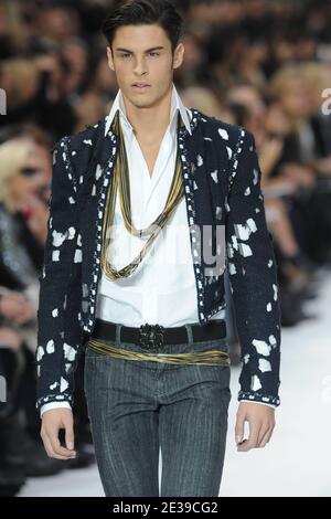 Baptiste Giabiconi displays a creation by Karl Lagerfeld for Chanel spring-summer  2011 ready-to wear collection presentation held at the Grand Palais in Paris,  France on October 5, 2010. Photo by Christophe Guibbaud/ABACAPRESS.COM